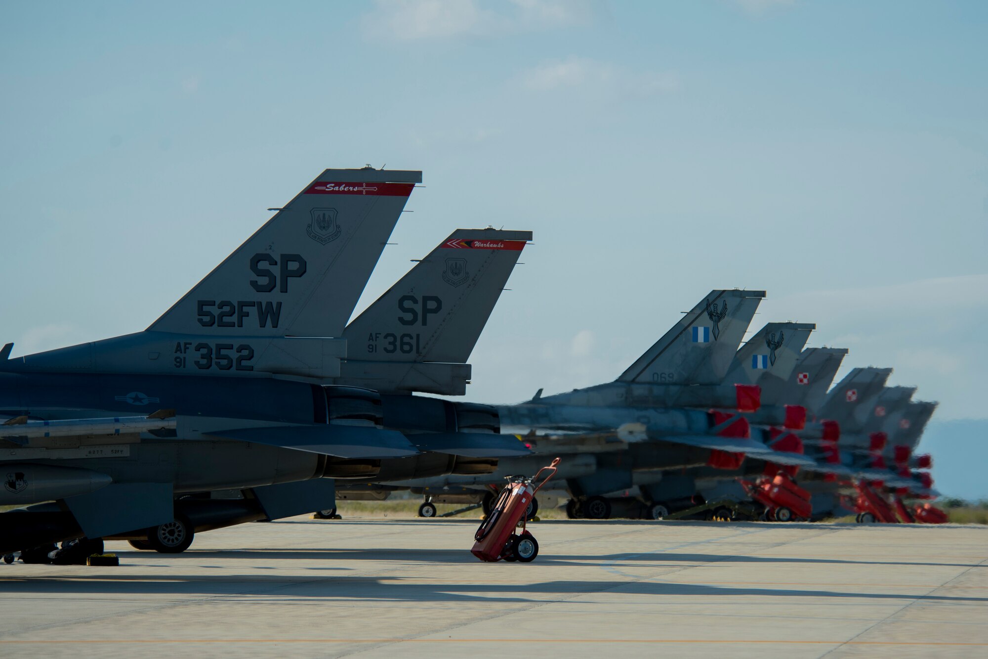 Two F-16 Fighting Falcon fighter aircraft, assigned to 480th Fighter Squadron, Spangdahlem Air Base, Germany, park next to F-16s from the Hellenic air force and Polish air force after the Trapani Air Show at Trapani Air Base, Italy, Oct. 19, 2015. The Trapani Air Show kicked off Trident Juncture 2015, a training exercise involving more than 30 Allied and Partner Nations taking place throughout Italy, Portugal, Spain, the Atlantic Ocean, the Mediterranean Sea, Canada, Norway, Germany, Belgium and the Netherlands. (U.S. Air Force photo by Airman 1st Class Luke Kitterman/Released)
