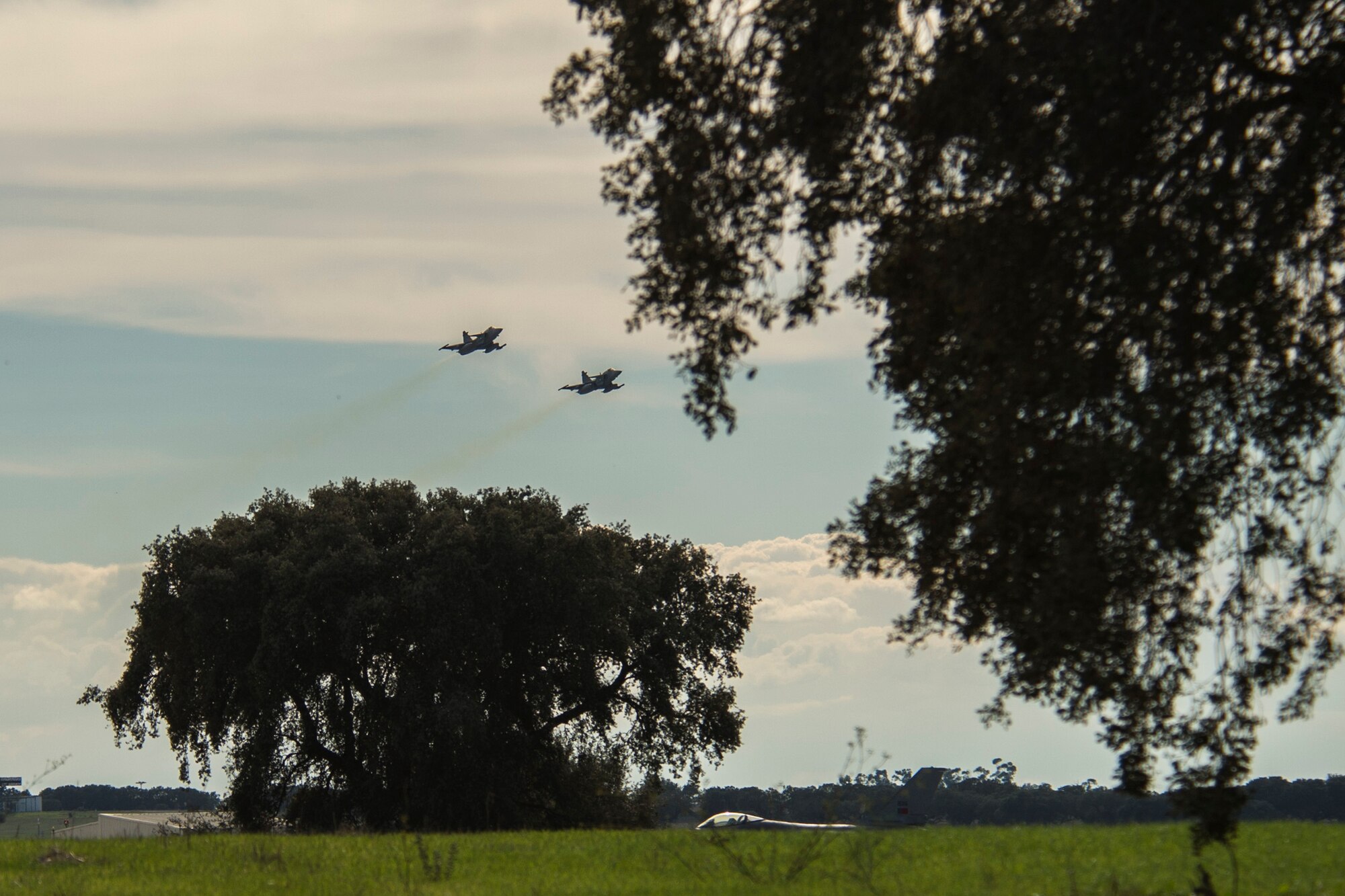 BEJA AIR BASE, Portugal - Two F-16 fighter aircraft fly over the Beja Air Base, Portugal  flightline Oct. 21, 2015. Several F-16 Fighting Falcon fighter aircraft, pilots and support personnel assigned to the 52nd Fighter Wing, Spangdahlem Air Base, Germany, are here to participate in Exercise Trident Juncture 2015, a multiservice, multinational exercise geared toward demonstrating NATOs ability to respond on a large scale to a crisis scenario. (U.S. Air Force photo by Airman 1st Class Luke Kitterman/Released)