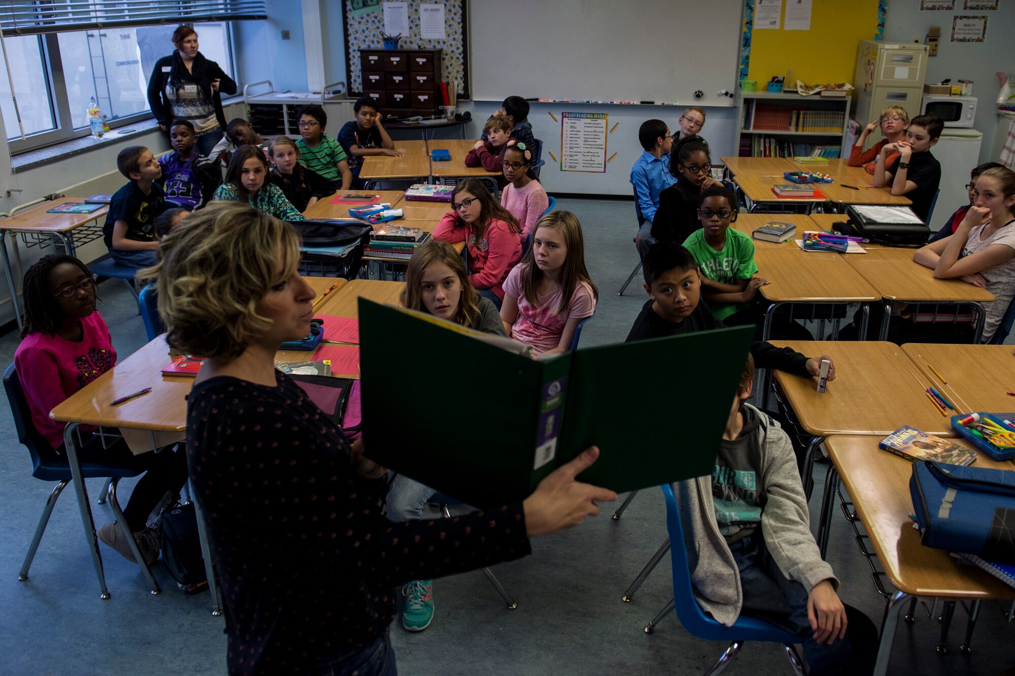 Jennifer Hensley, a Bitburg American Middle-High School teacher, reads to students  during a reading session for a Read Across the Globe event inside Spangdahlem Middle School Oct. 20, 2015, at Spangdahlem Air Base, Germany. Hosted by the American Red Cross and Points of Light, the event aimed to break the world record for the most kids read to in a 24-hour period. (U.S. Air Force photo by Senior Airman Rusty Frank/Released)