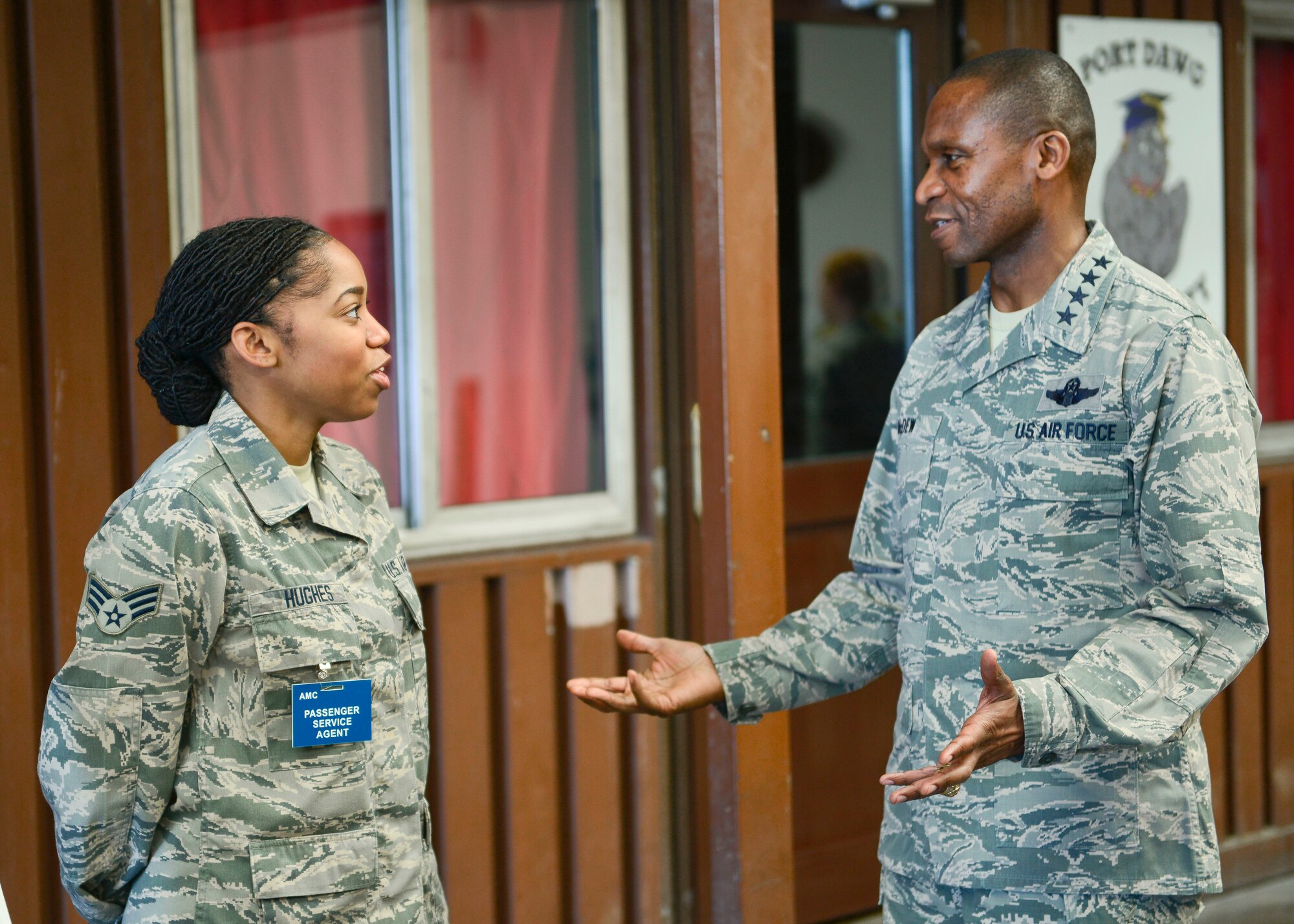 Senior Airmen Shavonda Hughes, 728th Air Mobility Squadron passenger services agent, speaks with Gen. Darren McDew, U.S. Transportation Command commander Oct. 17, 2015, at Incirlik Air Force Base, Turkey. Hughes discussed with McDew the capabilities of the 728th AMS passenger terminal and what the squadron offers to Airmen who are stationed and deployed to Incirlik AB. (U.S. Air Force photo by Airman 1st Class Cory W. Bush/Released)