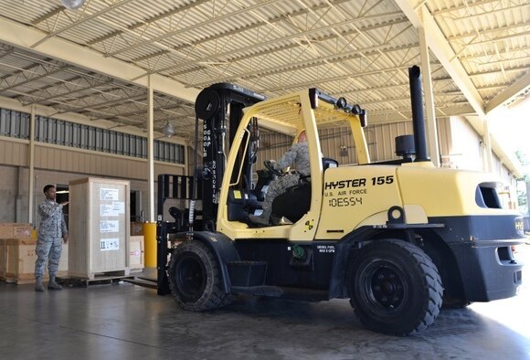 Airman 1st Class Kristoffer Ferguson, 96th Logistics Readiness Squadron F-35 supply apprentice, directs Senior Airman Derrick Nuzum, 96th LRS F-35 supply journeyman, as he moves a crate using a fork lift Oct. 15 at Eglin Air Force Base, Fla. Materiel management Airmen provide necessary equipment and supplies for Air Force operations such as aircraft parts and equipment necessary for the mission. (U.S. Air Force Photo/Senior Airman Andrea Posey)