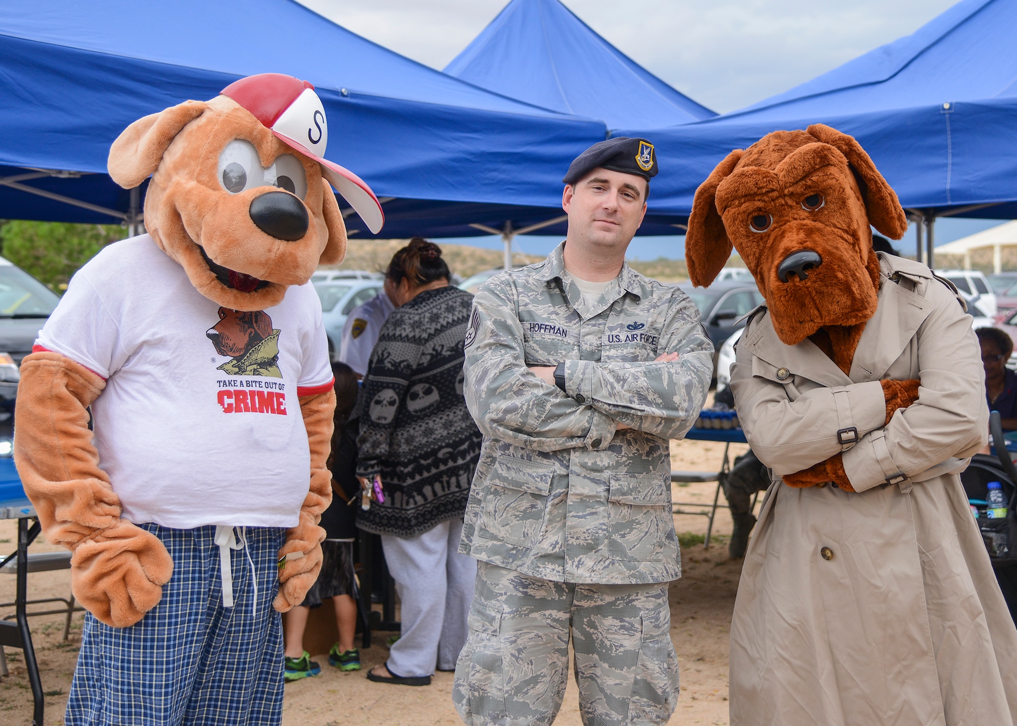 Staff Sgt. Jason Hoffman, 412th Security Forces Squadron, poses for a quick photo with McGruff the Crime Dog and his nephew Scruff. (U.S. Air Force photo by Rebecca Amber)
