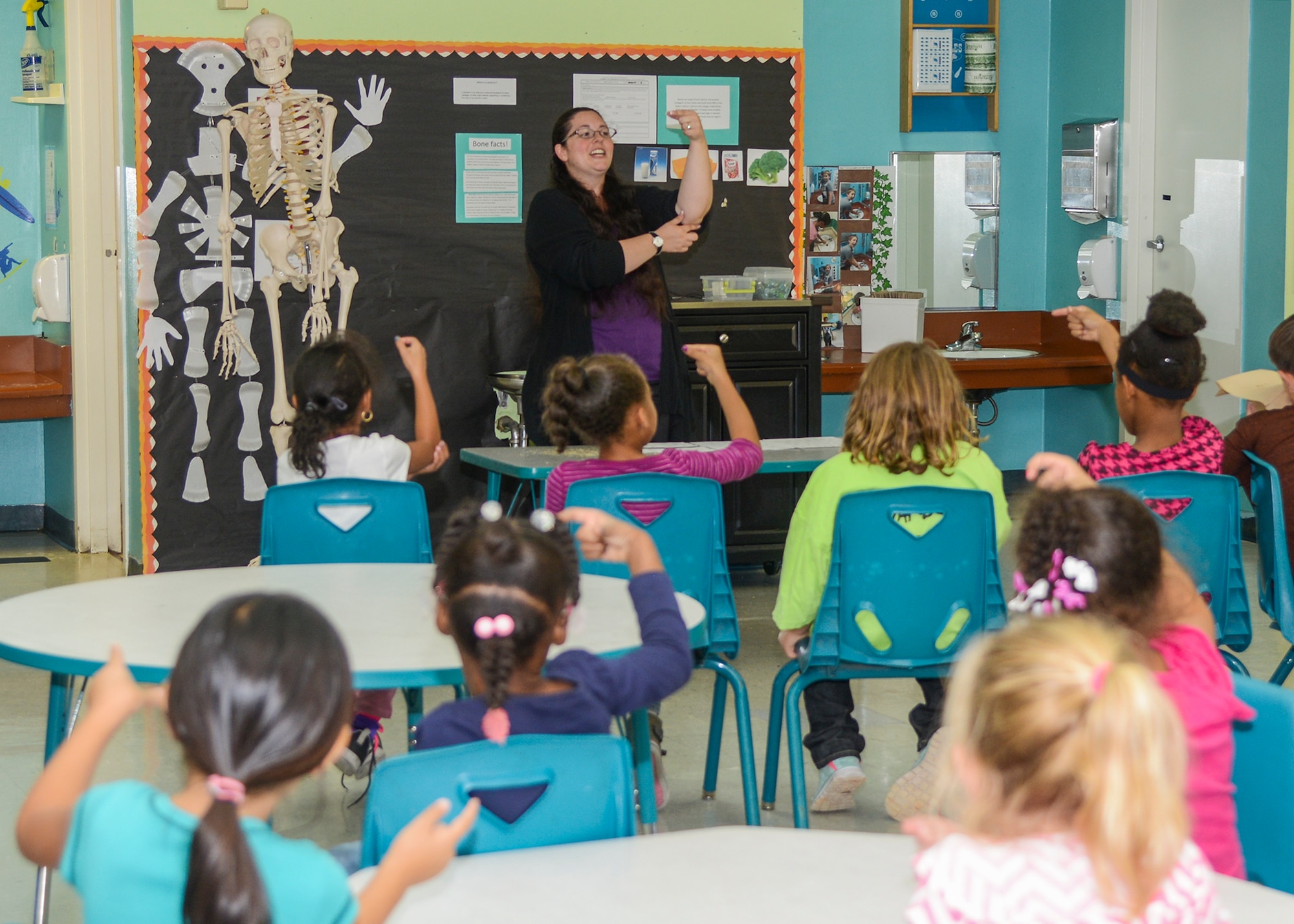 Amber Ludwig, 412th Test Wing American Sign Language interpreter, teaches children at the School Age Annex basic signs in honor of National Disability Employment Awareness Month. (U.S. Air Force photo by Rebecca Amber)