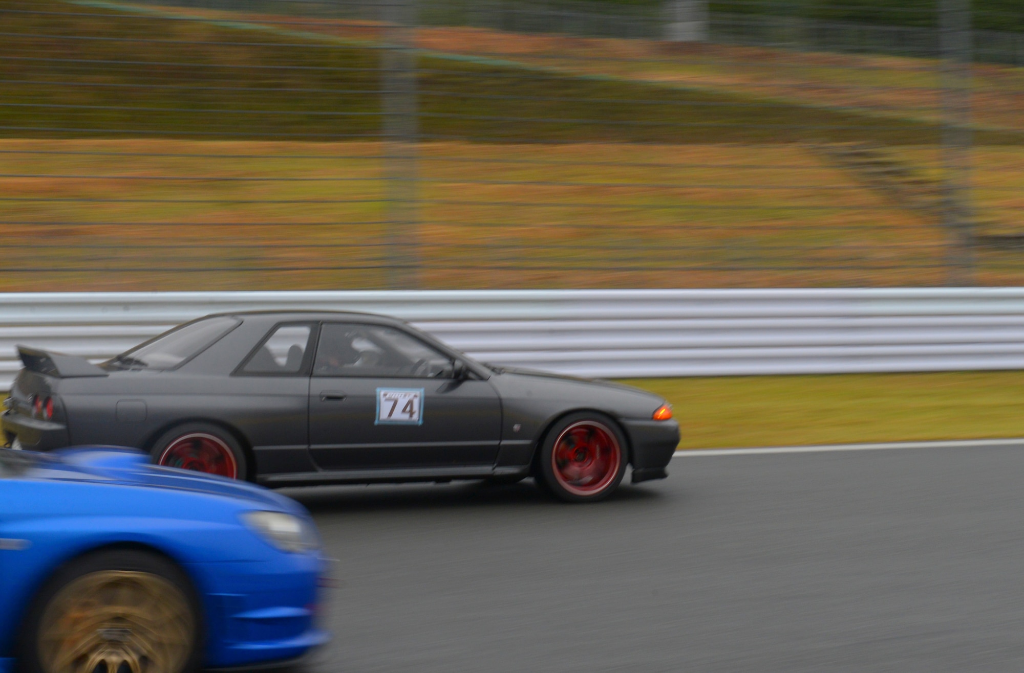 Senior Airman Thomas Kirts, 374th Civil Engineer Squadron driver operator, races a competitor at Fuji Speedway, Japan, Oct. 17, 2015. Kirts participated in two 30 minute heats, which were casual races for the enjoyment of the competitors. (U.S. Air Force photo by Airman 1st Class Elizabeth Baker/Released)