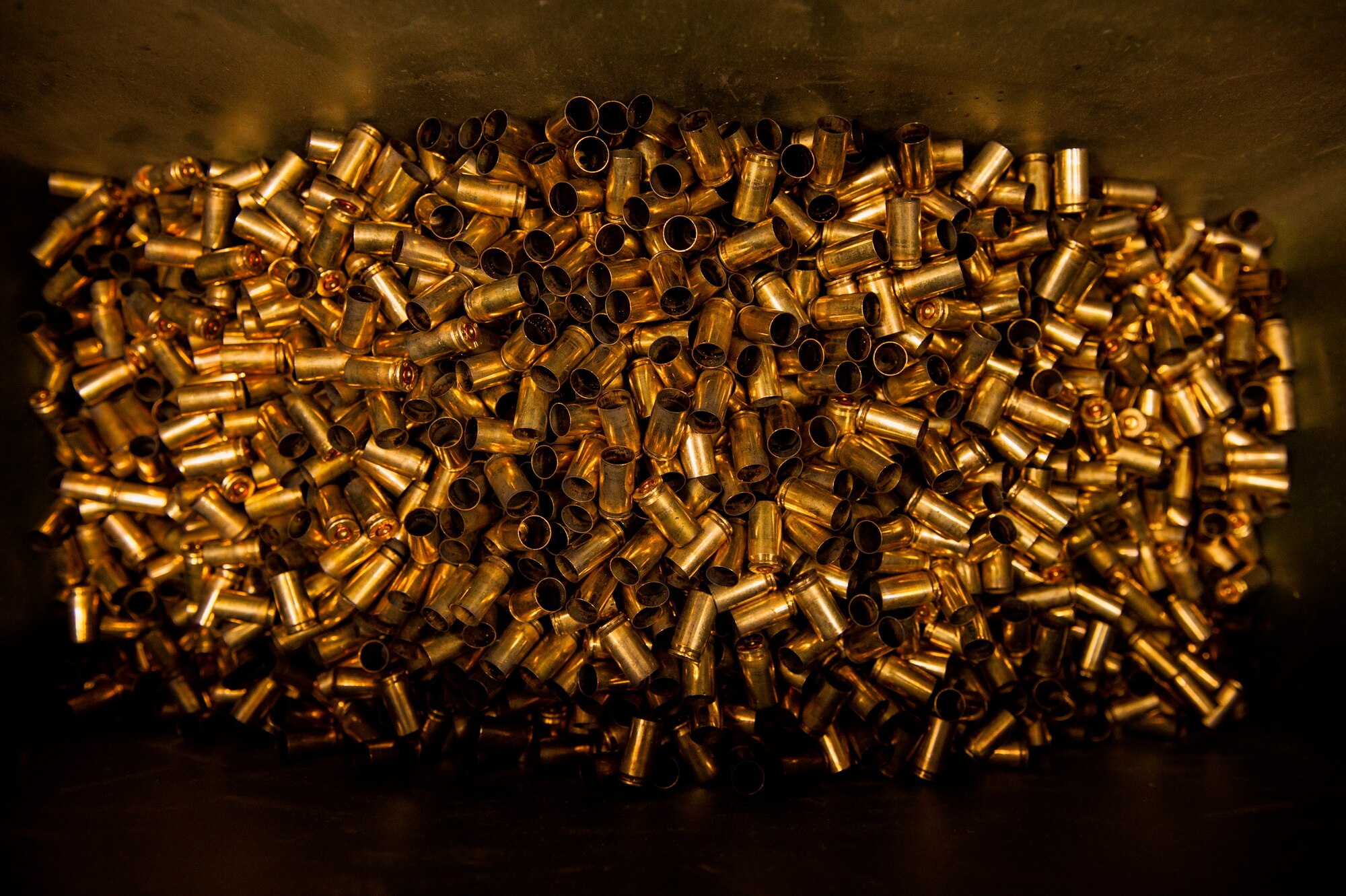 Bullet shells fill a bin at a firing range at Yokota Air Base, Japan, Oct. 8, 2015. Airmen use 5.56 millimeter when performing M-4 carbine qualifying sessions. (U.S. Air Force photo by Airman 1st Class Delano Scott/Released)