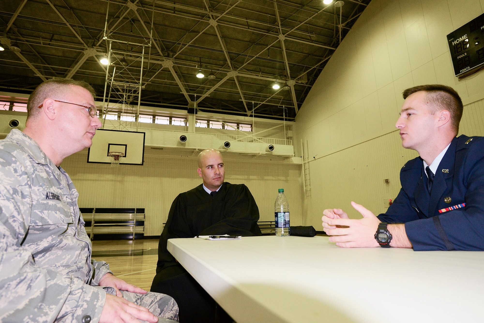 Capt. Thomas Prochazka and 1st Lt. Timothy Oster, 374th Airlift Wing assistant judge advocates, outline possible charges for a simulated driving under the influence case to Chief Master Sgt. Reynold Albright, 374th Operations Group command chief, during a DUI Rodeo at Yokota Air Base, Japan, Oct. 16, 2015. The rodeo had participants go through a DUI incident, a mock trial and a station manned by Alcohol and Drug Abuse Prevention and Treatment Program representatives. (U.S. Air Force photo by Senior Airman David C. Danford/Released)