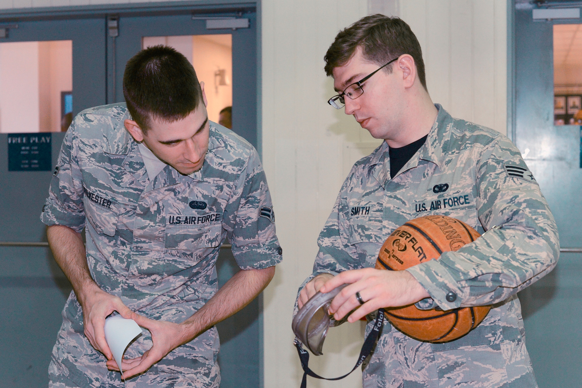 Senior Airman Ryan Smith, 374th Security Forces Squadron patrolman, displays a pair of ‘drunk goggles’ to an Airman while manning a station at a driving under the influence rodeo at Yokota Air Base, Japan, Oct. 16, 2015. The 374 SFS held the rodeo to educate base personnel on the effects of drinking and the consequences of drunk driving. (U.S. Air Force photo by Senior Airman David C. Danford/Released)