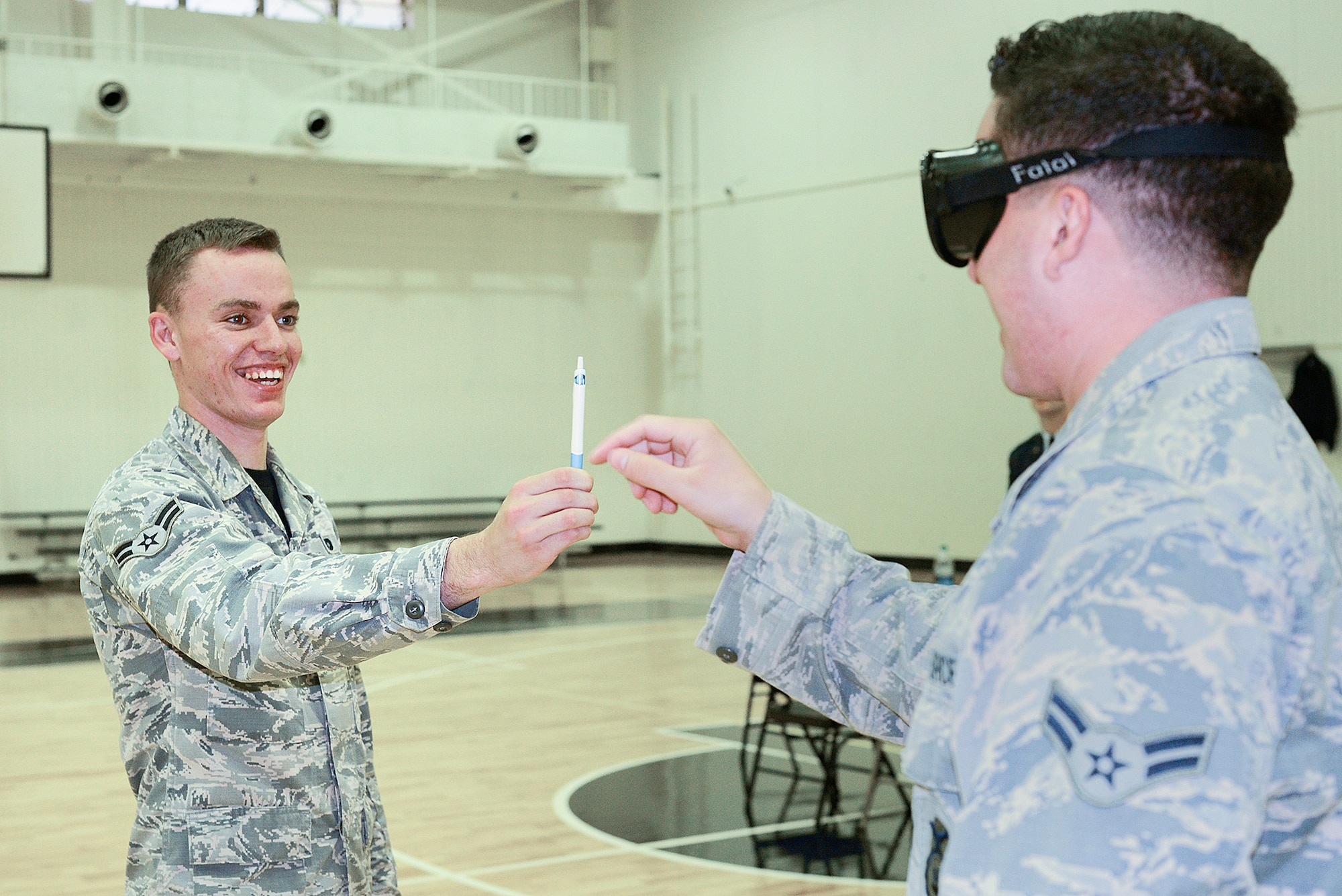 Airman 1st Class Quentin Lequieu, 374th Security Forces Squadron patrolman, administers a field sobriety test to an airman wearing ‘drunk goggles’ during a driving under the influence rodeo at Yokota Air Base, Japan, Oct. 16, 2015. The goggles simulate a blood alcohol content level of 0.2, over twice the legal limit. (U.S. Air Force photo by Senior Airman David C. Danford/Released)