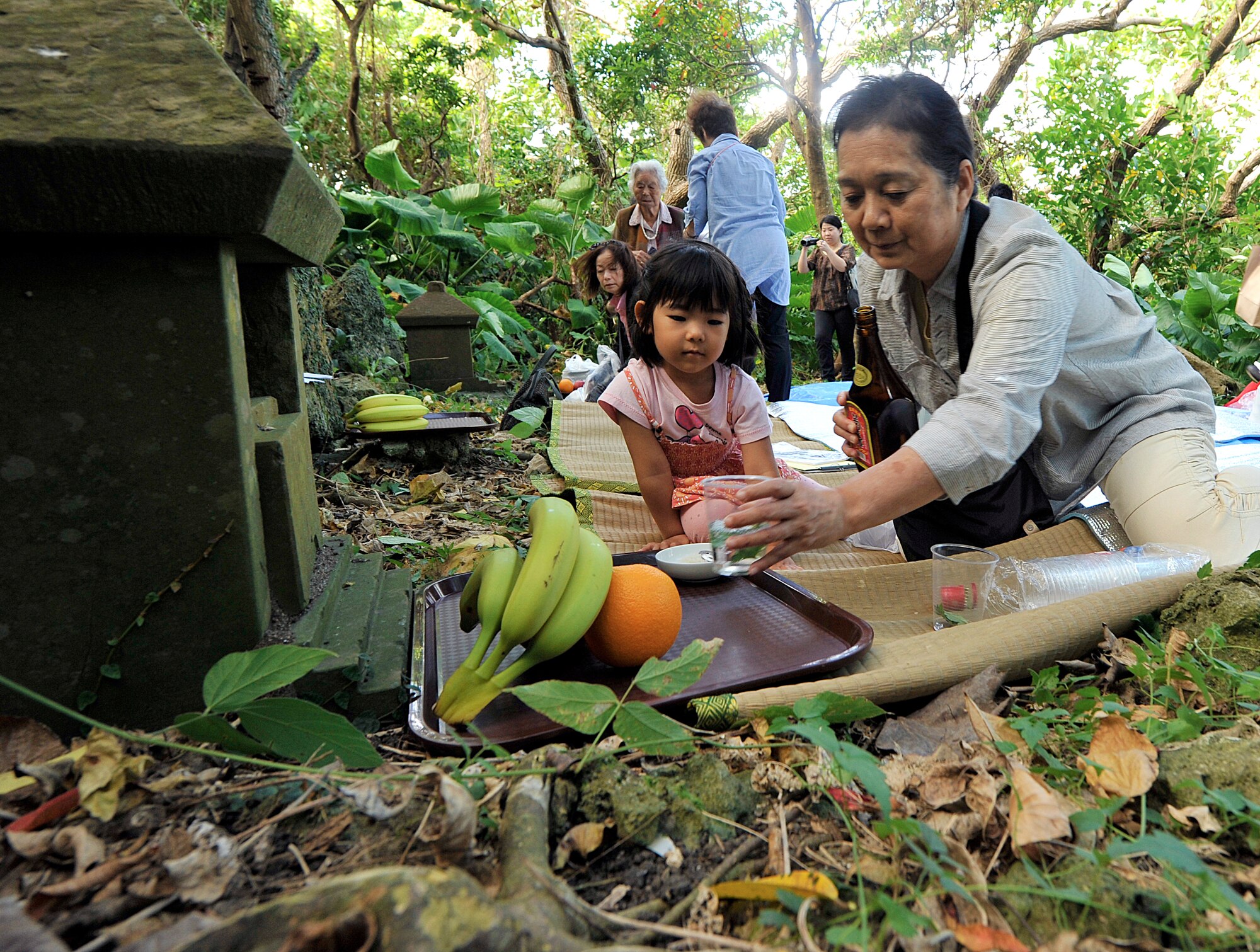 A local Okinawan prepares a ceremonial meal in front of a tomb at the Morine Bijiru during the annual sacred sites visit Oct. 21, 2015, on Kadena Air Base, Japan. The purpose of the visit is to give the local Okinawans an opportunity to pray for the safety, happiness and health of family members and also to show respect to their ancestors where they once lived. (U.S. Air Force photo by Naoto Anazawa)
