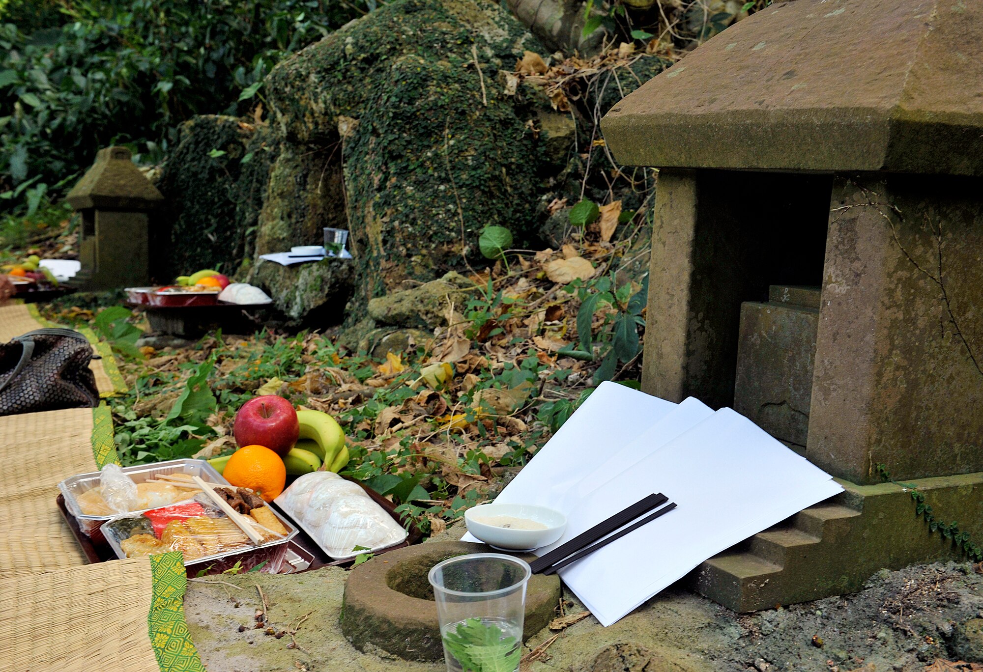 Ceremonial meals are displayed in front of tombs during the annual sacred sites visit at the Morine Bijiru Oct. 21, 2015, on Kadena Air Base, Japan. The Morine was once known as the colonies of exiled samurais and later it became an independent section of Goeku Village around the Taisho to Showa era in the 1920s. (U.S. Air Force photo by Naoto Anazawa)