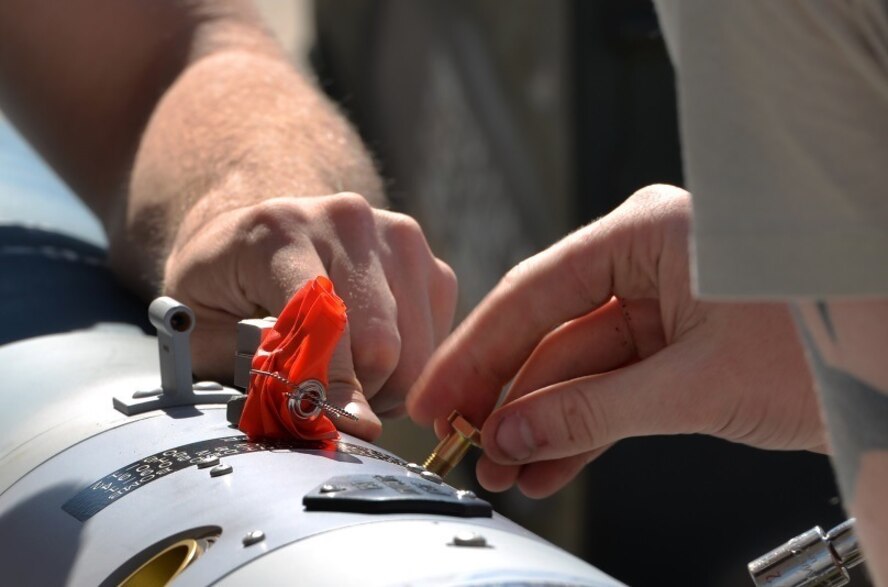 The 33rd Aircraft Maintenance Squadron Airmen prepare to load a missile-guided bomb onto an F-35A Lightning II Oct. 16 at Eglin Air Force Base, Fla. Load crew members assembled the missile before loading it onto the F-35. (U.S. Air Force Photo/Senior Airman Andrea Posey)