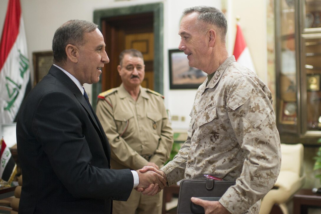 Iraqi Minister of Defense, Khaled al-Obaidi, shakes hands with U.S. Marine Corps Gen. Joseph F. Dunford Jr., chairman of the Joint Chiefs of Staff, at the Iraq Ministry of Defense in Baghdad, Iraq, Oct. 20, 2015. DoD photo by D. Myles Cullen