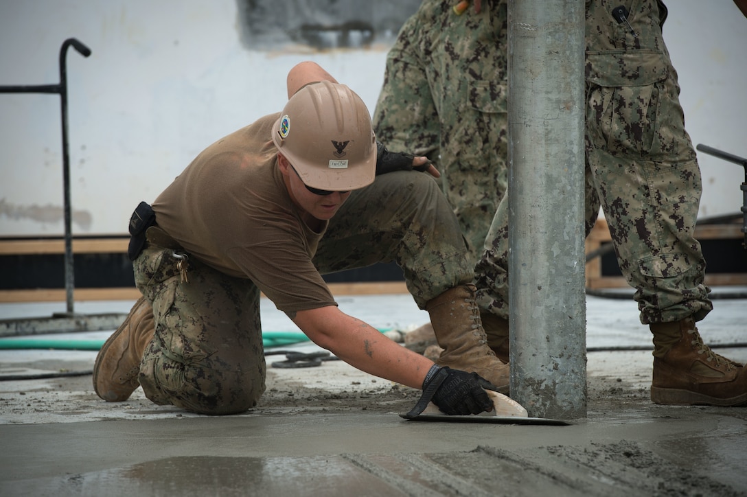 U.S. Navy Petty Officer 2nd Class Whitney Taylor uses a magnesium float to smooth concrete during a construction placement project on Naval Base Guam, Guam, Oct. 20, 2015. Taylor is a builder assigned to Naval Mobile Construction Battalion 1. U.S. Navy photo by Petty Officer 1st Class Ace Rheaume
