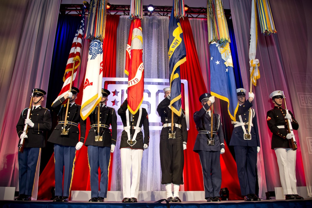 The joint service color guard displays the American and service flags during the 2015 USO Gala in Washington, D.C., Oct. 20, 2015.  U.S. Marine Corps photo by Sgt. Gabriela Garcia
