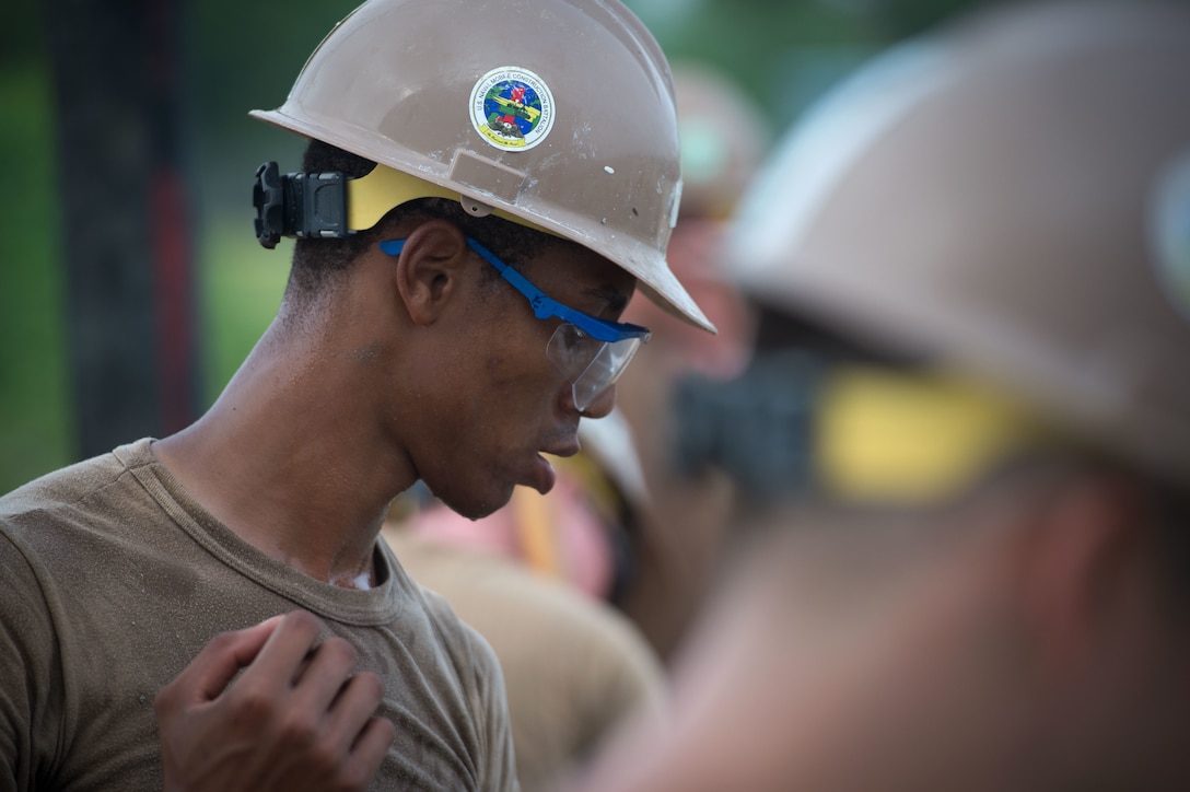 U.S. Navy Seaman Kenard Bommon helps place concrete during a construction project on Naval Base Guam, Guam, Oct. 20, 2015. Bommon is a utilitiesman constructionman apprentice assigned to Naval Mobile Construction Battalion 1. U.S. Navy photo by Petty Officer 1st Class Ace Rheaume