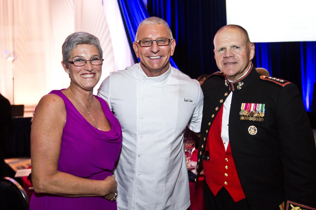 Marine Corps Commandant Gen. Robert B. Neller, right, and his wife, D'Arcy Neller, left, pose with Chef Robert Irvine during the 2015 USO Gala in Washington, D.C., Oct. 20, 2015. The USO and an estimated 1,000 guests gathered to recognize the soldier, sailor, airman, Marine, Coast Guardsman, and National Guardsman of the year. U.S. Marine Corps photo by Sgt. Gabriela Garcia