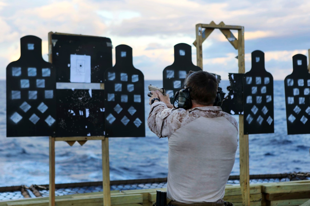 A U.S. Marine fires the M45-A1 pistol during a deck shoot aboard the USS Arlington in the Atlantic Ocean, Oct. 12, 2015. The Marine is assigned to Force Reconnaissance Platoon, Maritime Raid Force, 26th Marine Expeditionary Unit. U.S. Marine Corps photo by Cpl. Jeraco Jenkins