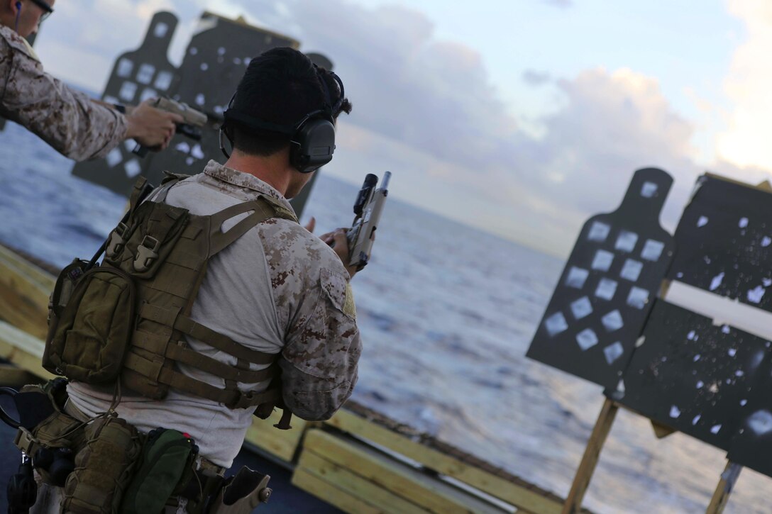 A U.S. Marine reloads his M45-A1 pistol during a deck shoot aboard the USS Arlington in the Atlantic Ocean, Oct. 12, 2015. U.S. Marine Corps photo by Cpl. Jeraco Jenkins