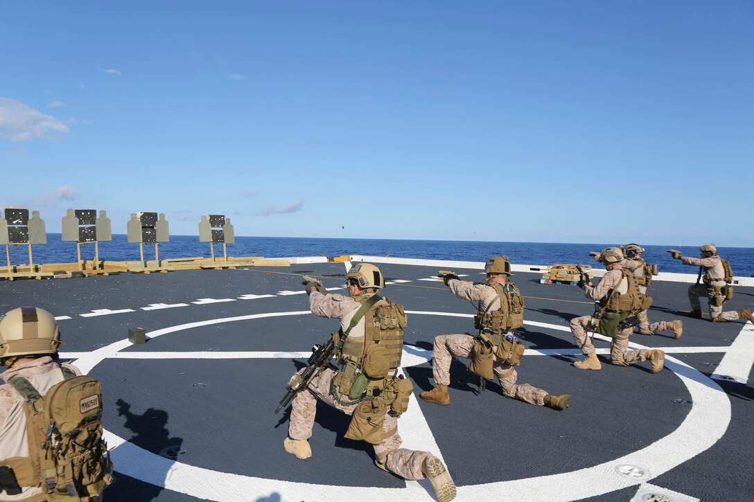U.S. Marines engage stationary targets with the M45-A1 pistol during a deck shoot aboard the USS Arlington in the Atlantic Ocean, Oct. 12, 2015. U.S. Marine Corps photo by Cpl. Jeraco Jenkins