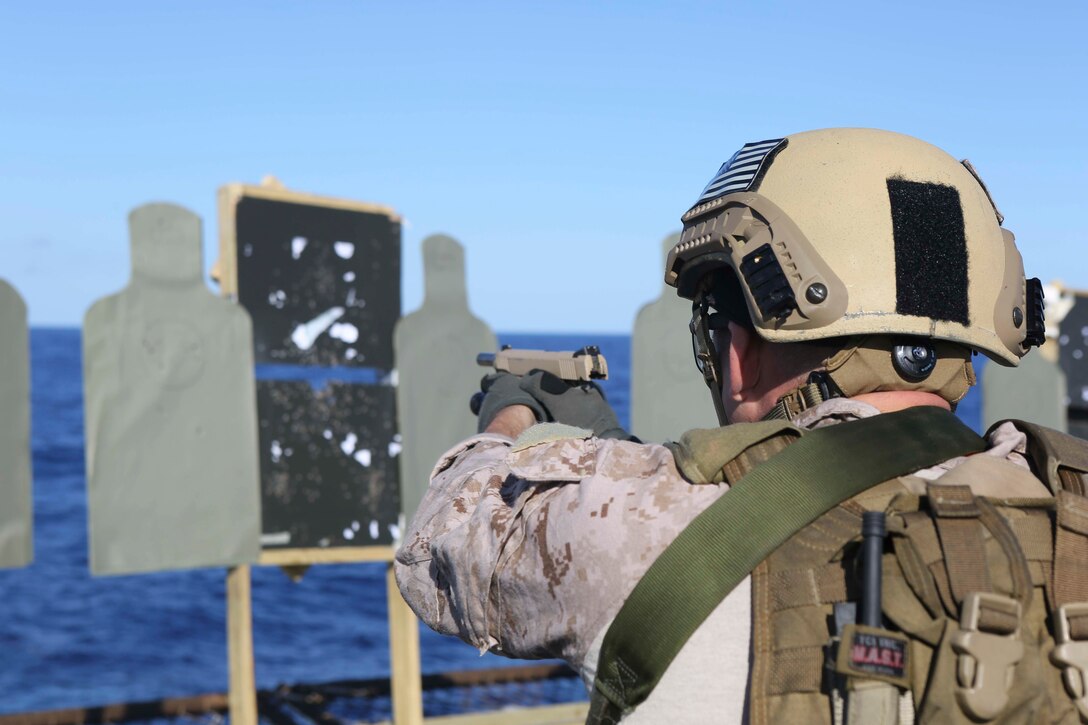 A U.S. Marine fires an M45-A1 pistol during a deck shoot aboard the USS Arlington in the Atlantic Ocean, Oct. 12, 2015. U.S. Marine Corps photo by Cpl. Jeraco Jenkins



