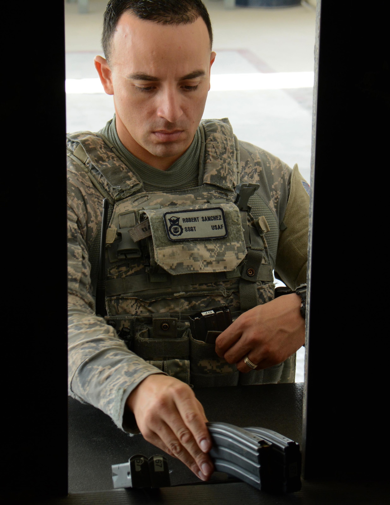 Staff Sgt. Robert Sanchez, 379th Security Forces Squadron, receives ammunition from the 379th SFS Armory at Al Udeid Air Base, Qatar Oct. 22. Security Forces Airmen Airmen are issued a wide range of equipment and weapons from the armory to protect the base including radios, batons, pistols and rifles. The 379th SFS Armory maintains more than $5 million in weapons and equipment. (U.S. Air Force photo/Tech. Sgt. James Hodgman)