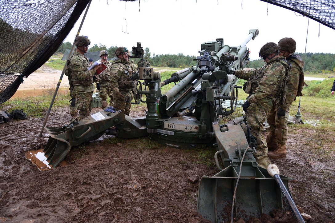 U.S. soldiers prepare to fire an M119 howitzer during Exercise Rock Proof V at Pocek Range in Postonja, Slovenia, Oct. 15, 2015. U.S. Army photo by Paolo Bovo