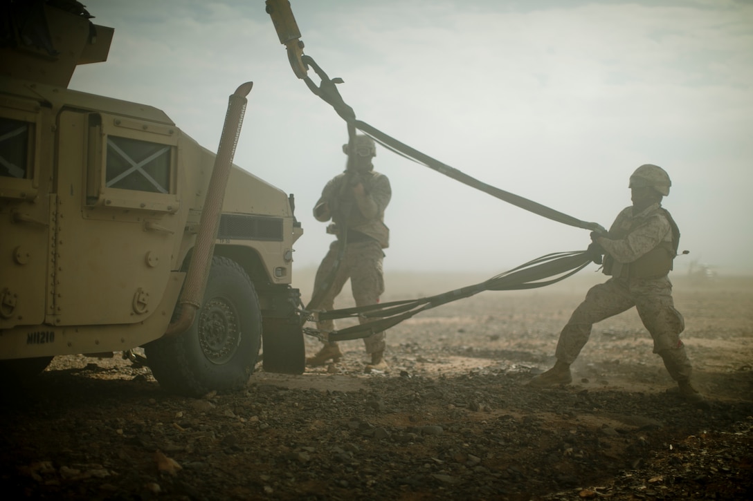 Marine Corps Lance Cpl. Brianna Hitchcock, right, helps prepare a Humvee for transport via a CH-53E Super Stallion helicopter during an assault support tactics exercise at Landing Zone Bull, Chocolate Mountain Aerial Gunnery Range, Calif., Oct. 12, 2015. Hitchcock is a landing support specialist assigned to Landing Support Company, 1st Transportation Support Battalion, 1st Combat Logistics Regiment. U.S. Marine Corps photo by Cpl. Summer Dowding