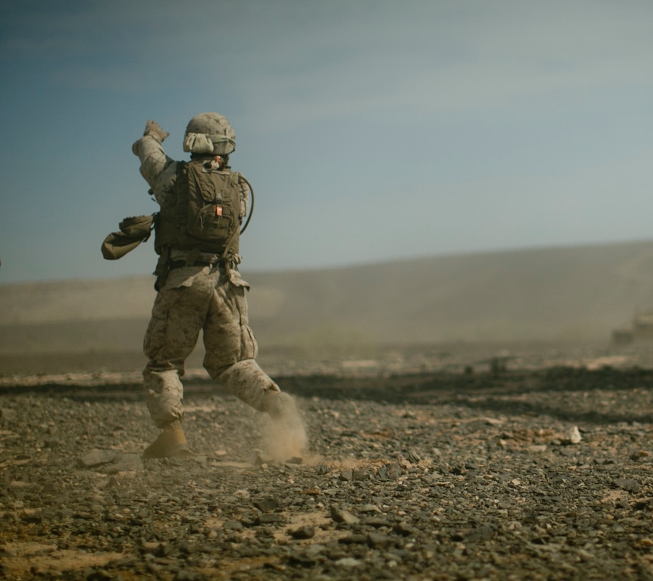 Marine Corps Lance Cpl. Nathaniel Haynes signals a CH-53E Super Stallion helicopter as it approaches for sling-load operations during an assault support tactics exercise at Landing Zone Bull, Chocolate Mountain Aerial Gunnery Range, Calif., Oct. 12, 2015. Haynes is a landing support specialist assigned to Landing Support Company, 1st Transportation Support Battalion, 1st Combat Logistics Regiment. U.S. Marine Corps photo by Cpl. Summer Dowding 