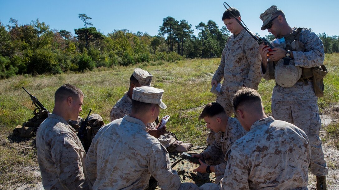 Marines with 3rd Battalion, 6th Marine Regiment are instructed on how to load frequencies into a radio during lane training at Marine Corps Base Camp Lejeune, N.C., Oct. 20, 2015. The Marines conducted lane training to further increase their proficiency as basic infantrymen. The training consisted of four stations, each of which would provide instructions and hands-on training in radio communications, grenade employment, patrolling and emplacing a M18 Claymores.