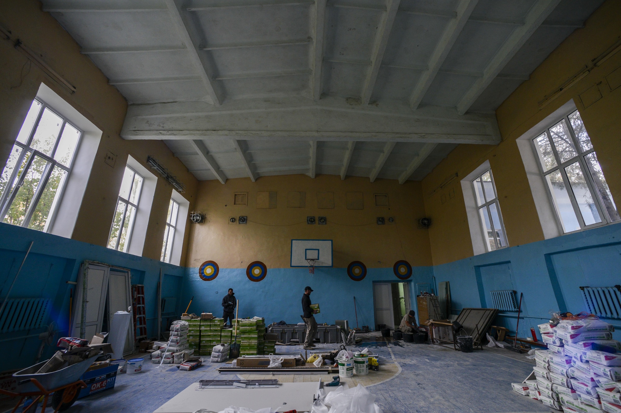 Airmen from the 435th Construction and Training Squadron and 52nd Civil Engineer Squadron mix cement for renovations in a locker room Oct. 18, 2015, at Liceul Teoretic Alexei Mateevici School in Sanatauca, Moldova. At least seven Airmen from the 435th CTS and the 52nd Civil Engineer Squadron worked on the renovations since Sept. 23. The Moldova Humanitarian and Civic Assistance program is part of a military and civilian theater security cooperation program the U.S. European Command uses to directly impact civilian communities throughout 17 countries, primarily in Eastern Europe. (U.S. Air Force photo/Senior Airman Nicole Sikorski)