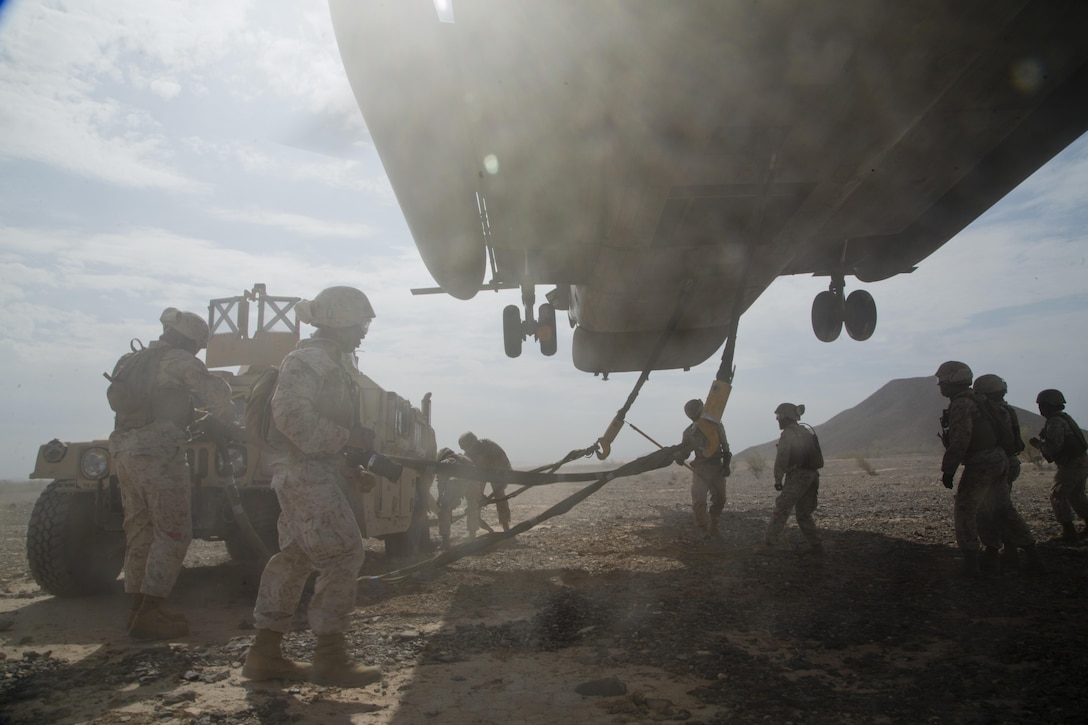 Marines prepare a Humvee for transport via sling load by a CH-53E Super Stallion helicopter during an assault support tactics exercise at Landing Zone Bull, Chocolate Mountain Aerial Gunnery Range, Calif., Oct. 12, 2015. U.S. Marine Corps photo by Cpl. Summer Dowding       
