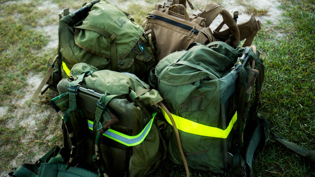 Packs weighing approximately 45 pounds wait to be carried by scout sniper screener candidates during a physical fitness assessment at Marine Corps Base Camp Lejeune, N.C., Oct. 20, 2015. The screener aims to prepare candidates for the Scout Sniper Basic Course. 