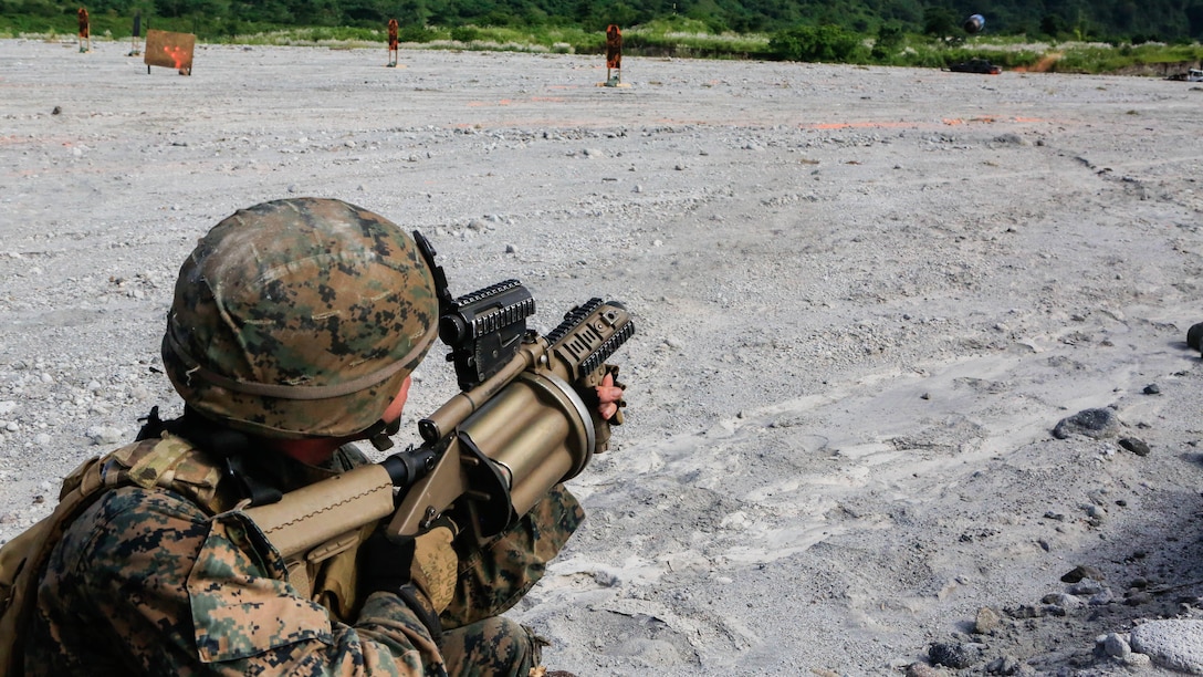 U.S. Marine Lance Cpl. Justin Sabey, a rifleman with Battalion Landing Team 2nd Battalion, 5th Marines, 31st Marine Expeditionary Unit, fires his M32 grenade launcher during live-fire training with Philippine Marines at Crow Valley, Philippines, Oct. 6, 2015. Philippine Marines with 31st Marine Company, Marine Battalion Landing Team 1, Armed Forces of the Philippines, and the U.S. Marines with BLT 2/5, 31st MEU, are training side by side as part of Amphibious Landing Exercise 2015, an annual bilateral training exercise conducted by members of the Armed Forces of the Philippines alongside U.S. Marine and Navy Forces. 