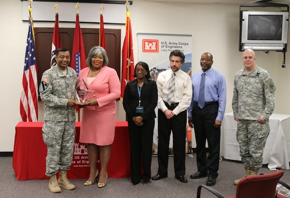 Lt. Gen. Thomas Bostick, U.S. Army Corps of Engineers commanding general presents the Fiscal Year 2014 Excellence in Contracting Awards Program, District of the Year Award to the Little Rock District contracting division.  Accepting the award is SWL Chief of Contracting Sandra Easter. 