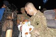 Spc. Alfredo Cañuelas-Gonzalez meets and holds his 2-month-old son for the first time on Oct. 15, 2015, during the 35th Signal Battalion homecoming.