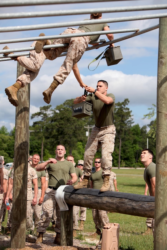 Marines with Headquarters and Headquarters Squadron maneuver an obstacle as a team during the bi-annual field meet at Marine Corps Air Station Cherry Point, N.C., May 22, 2015. Marines with H&HS and Marine Wing Headquarters Squadron 2 went head-to-head in a tug-of-war, a 7-ton pull, relay races and other events that tested the squadron’s teamwork and built camaraderie.