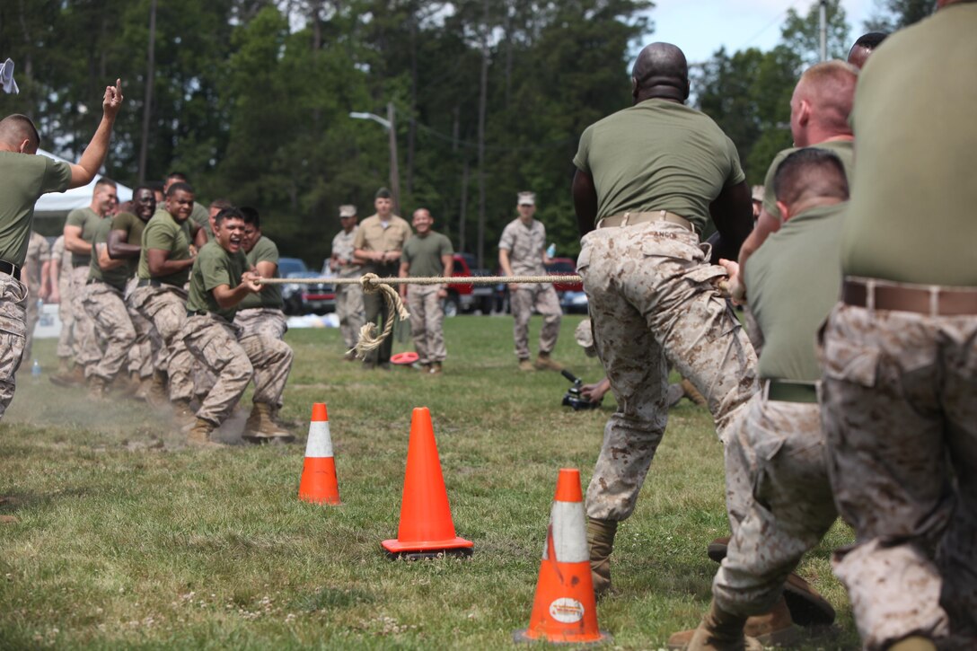 Marines with Headquarters and Headquarters Squadron and Marine Wing Headquarters Squadron 2 test their strength in a tug-of-war during the bi-annual field meet at Marine Corps Air Station Cherry Point, N.C., May 22, 2015. Marines with H&HS and MWHS-2 went head-to-head in a tug-of-war, a 7-ton pull, relay races and other events to build teamwork and camaraderie.