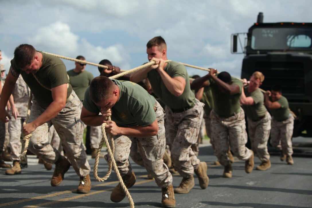 Marines with Marine Wing Headquarters Squadron 2 pull a seven-ton tactical vehicle during the bi-annual field meet against Headquarters and Headquarters Squadron at Marine Corps Air Station Cherry Point, N.C., May 22, 2015. Marines with H&HS and MWHS-2 went head-to-head in a tug-of-war, a 7-ton pull, relay races and other events to build teamwork and camaraderie.