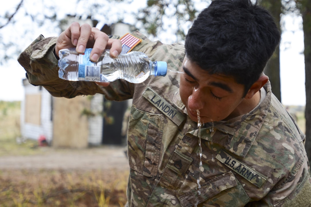 U.S. Army Staff Sgt. Hugo Landin rinses his face and mouth with water after coming out of the gas chamber during a training exercise in support of Operation Atlantic Resolve in Latvia, Oct. 21, 2015. OAR provides U.S. soldiers the opportunity to train alongside their NATO counterparts, forge relationships that foster trust and mutual understanding, strengthen interoperability, and demonstrates U.S. commitment to the alliance. Landin is a squad leader assigned to Attack Company 1-503rd Infantry Regiment, 173rd Airborne Brigade, Italy. U.S. Army photo by Staff Sgt. Steven Colvin