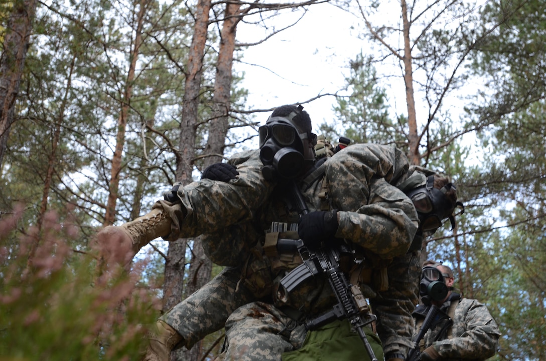 A U.S. soldier performs the fireman's carry on a simulated casualty during a chemical, biological, radiological and nuclear training exercise in support of Operation Atlantic Resolve in Latvia, Oct. 21, 2015. U.S. Army photo by Staff Sgt. Steven Colvin
