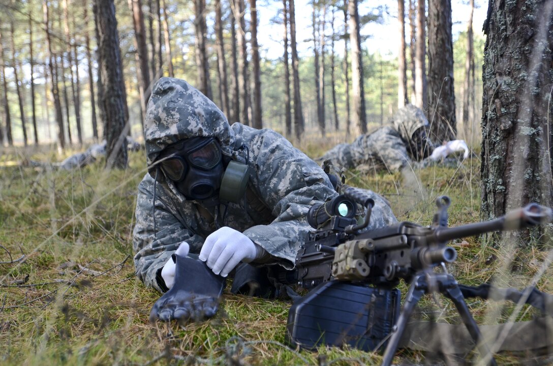 U.S. soldiers don gloves during a chemical, biological, radiological and nuclear training exercise in Latvia in support of Operation Atlantic Resolve, Oct. 21, 2015. The operation provides U.S. soldiers the opportunity to train alongside their NATO counterparts, forge relationships that foster trust and mutual understanding, strengthen interoperability and demonstrates U.S. commitment to the alliance. U.S. Army photo by Staff Sgt. Steven Colvin