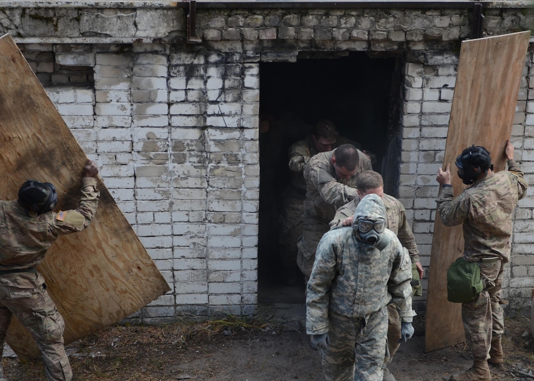 U.S. soldiers file out of the gas chamber during a chemical, biological, radiological and nuclear training exercise in support of Operation Atlantic Resolve in Latvia, Oct. 21, 2015. U.S. Army photo by Staff Sgt. Steven Colvin 