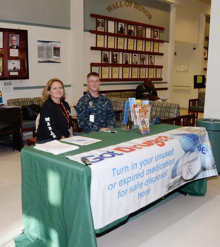 Kim Cleveland, program manager, Substance Abuse Counseling Center, Marine and Family Programs, Marine Corps Logistics Base Albany, and HN Wesley Balentine, preventive medicine technician, Naval Branch Health Clinic Albany, wait in the lobby of NBHC Albany to receive outdated or unused medications during the ‘Got Drugs?’ initiative, Oct. 21. Cleveland visited several locations on the installation to collect the medicines. The drive is an effort to ensure drugs are disposed of properly, decreasing the chance of unintended exposure to water supply systems and unauthorized usage. 
