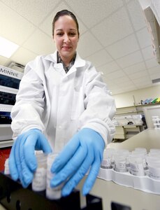 Tech. Sgt. Michelle Bernard unloads patient screening samples from a Roche 4810 machine in the molecular laboratory Oct. 7 at the San Antonio Military Medical Center, Joint Base San Antonio-Fort Sam Houston. Bernard recently received the Air Education and Training Command 2015 Lance P. Sijan U.S Air Force Leadership Award in the junior enlisted category.