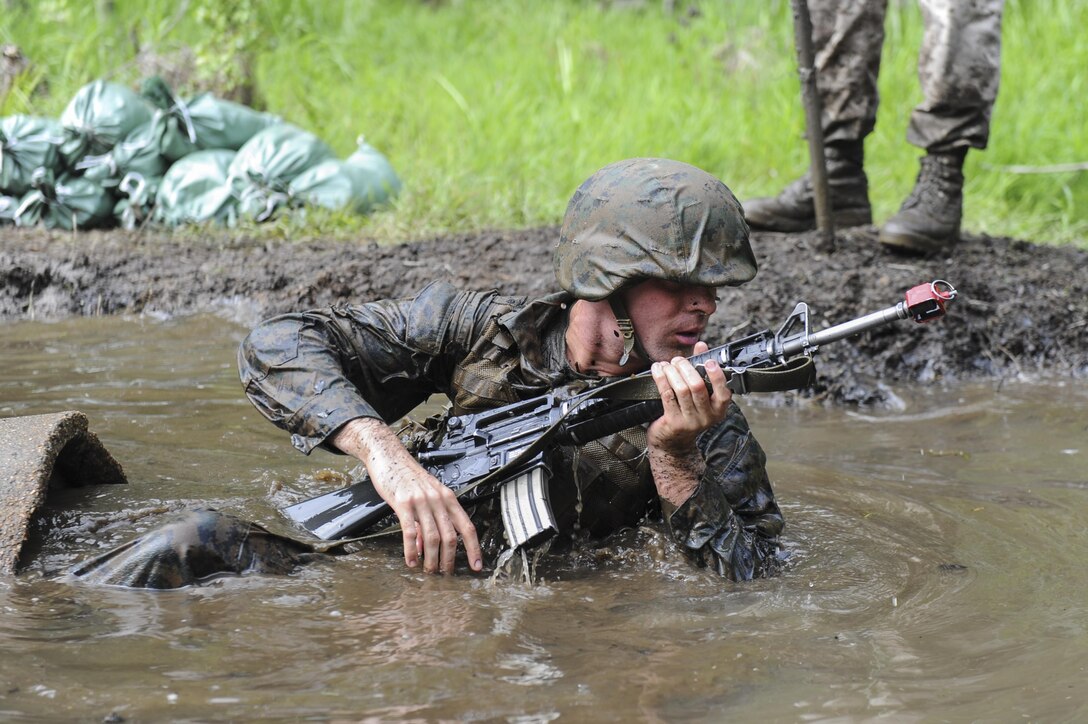 A candidate of Officer Candidate School executes the Combat Course aboard Marine Corps Base Quantico, June 14, 2013. The Marine Corps is looking for outstanding and qualified enlisted Marines to earn a commission and become second lieutenants through the Enlisted Commissioning Program. To apply for ECP, Marines must have a bachelor’s degree from a regionally or nationally accredited college or university, and be a lance corporal or above with at least one year time in service. The Marine Corps holds three ECP boards annually. For more information, visit http://www.marines.com/officer. (U.S. Marine Corps Photo by Lance Cpl. Kathryn K. Bynum/Released)