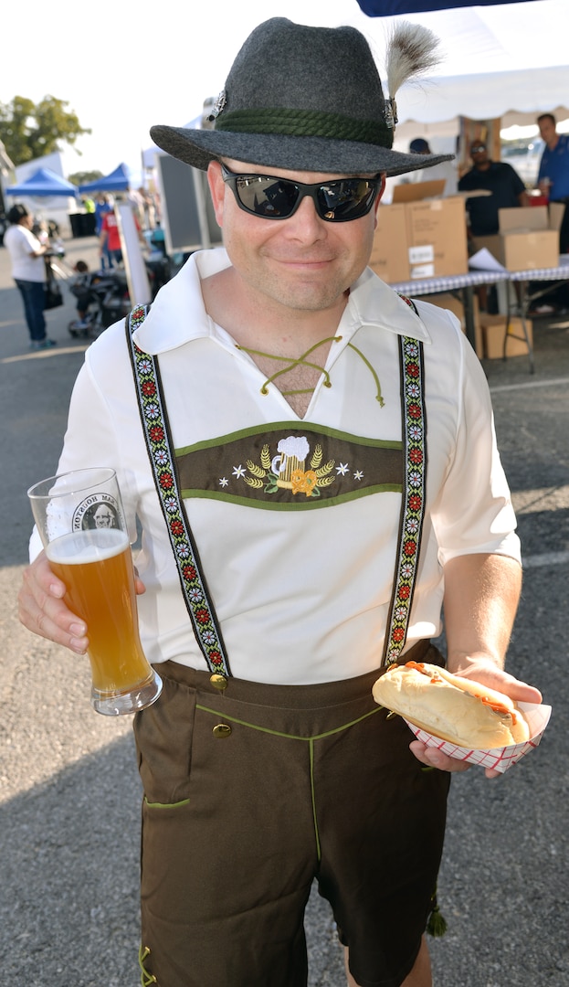 Capt. Tim Souza from U.S. Army North gets into the spirit of Oktoberfest Friday, complete with lederhosen, bratwurst and an adult beverage during the annual Joint Base San Antonio-Fort Sam Houston Oktoberfest celebration Friday. Attendees had the chance to sample a variety of food options, listen to live music and have the kids enjoys rides and crafts.