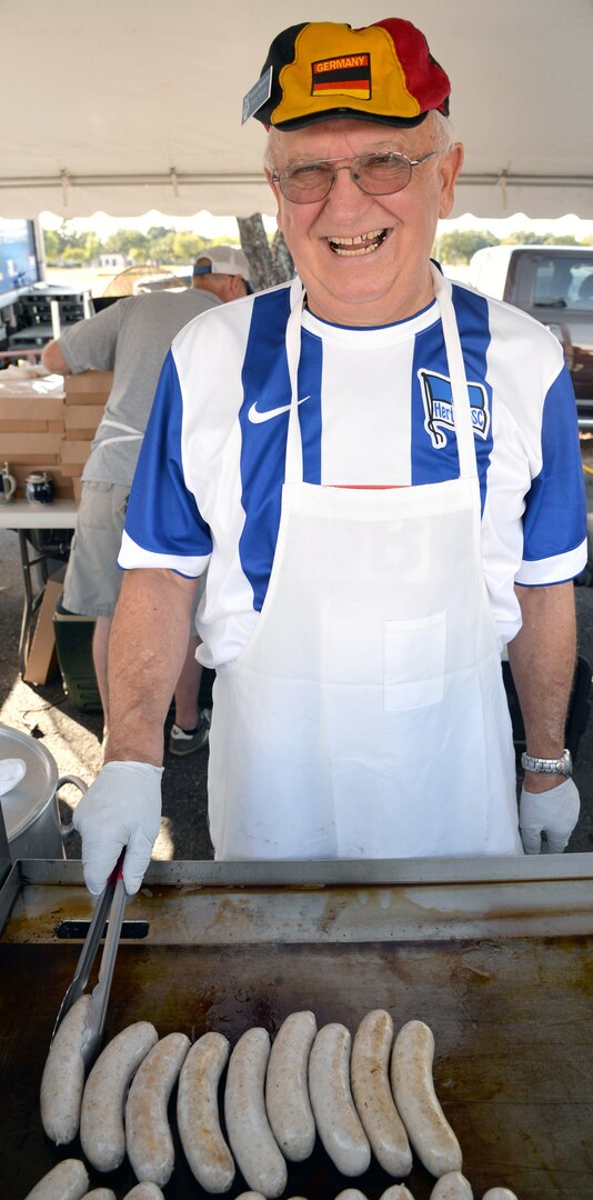 Herbert Kriese with Beethoven Mannerchor offers up the best of the wurst during the annual Joint Base San Antonio-Fort Sam Houston Oktoberfest celebration Friday.