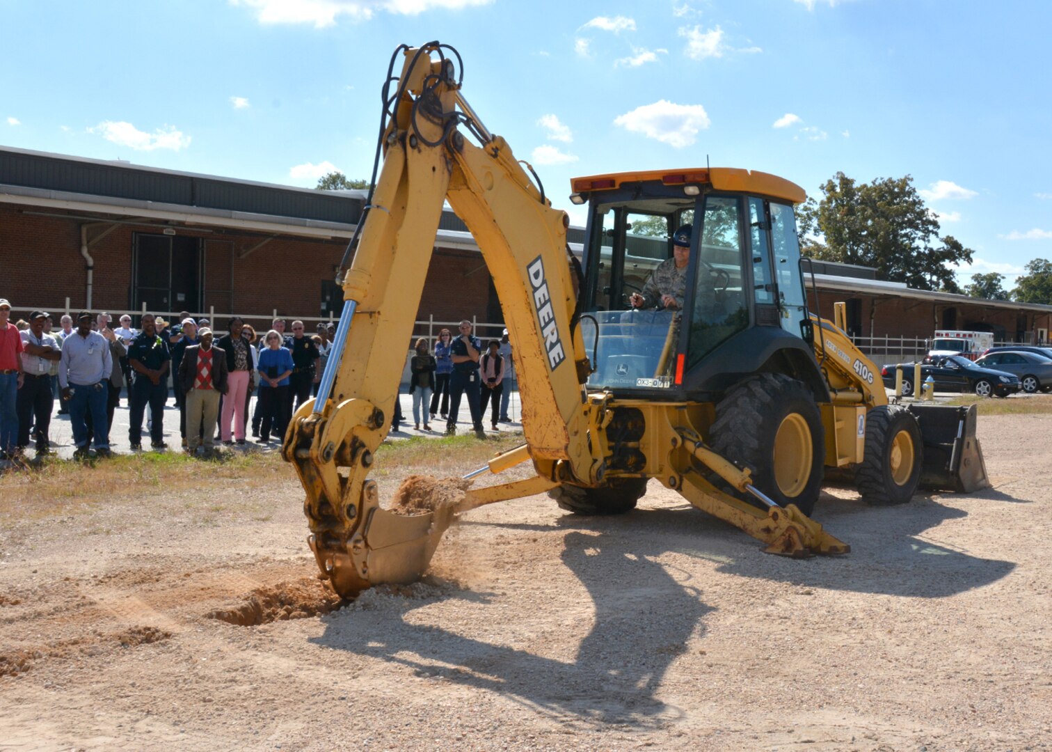 While attendees look on, Defense Logistics Agency Aviation Commander Air Force Brig. Gen. Allan Day breaks ground for the new Defense Logistics Agency Aviation Operations Center during a ceremony Oct. 15, 2015 on Defense Supply Center Richmond, Virginia.