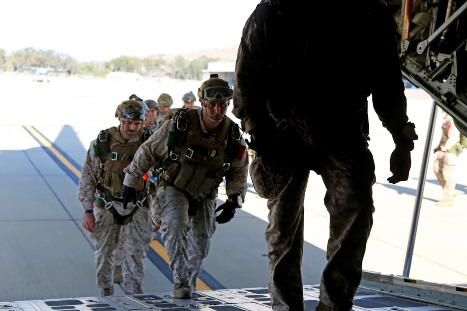 Marines with 1st Reconnaissance Battalion, 1st Marine Division enter a C-130 Hercules with 3rd Marine Aircraft Wing before executing static-line parachute operations and free fall jump training aboard Marine Corps Base Camp Pendleton, Calif., Oct. 16, 2015. 1st Recon conducted parachute operations in preparation for future deployments. (U.S. Marine Corps photo by Cpl. Demetrius Morgan/RELEASED)