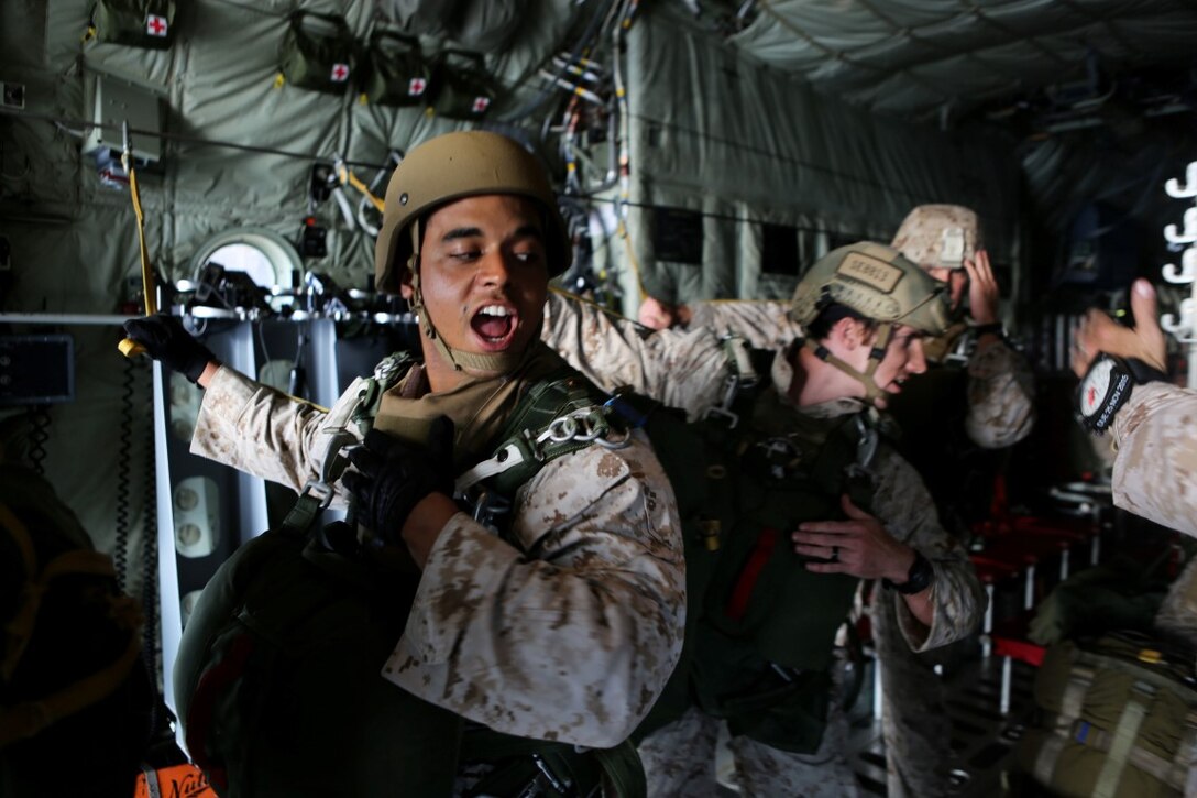 Corporal Kurtis Campbell, a jump team point man with 1st Reconnaissance Battalion, 1st Marine Division, relays commands to his team during static-line parachute operations aboard Marine Corps Base Camp Pendleton, Calif., Oct. 16, 2015. 1st Recon conducted parachute operations in preparation for future deployments. (U.S. Marine Corps photo by Cpl. Demetrius Morgan/RELEASED)